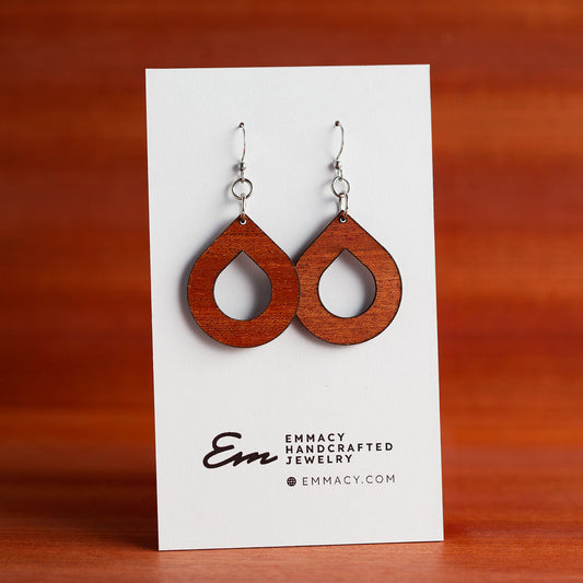 Laser cut wooden dangle earrings in teh shape of a teardrop with the center removed.