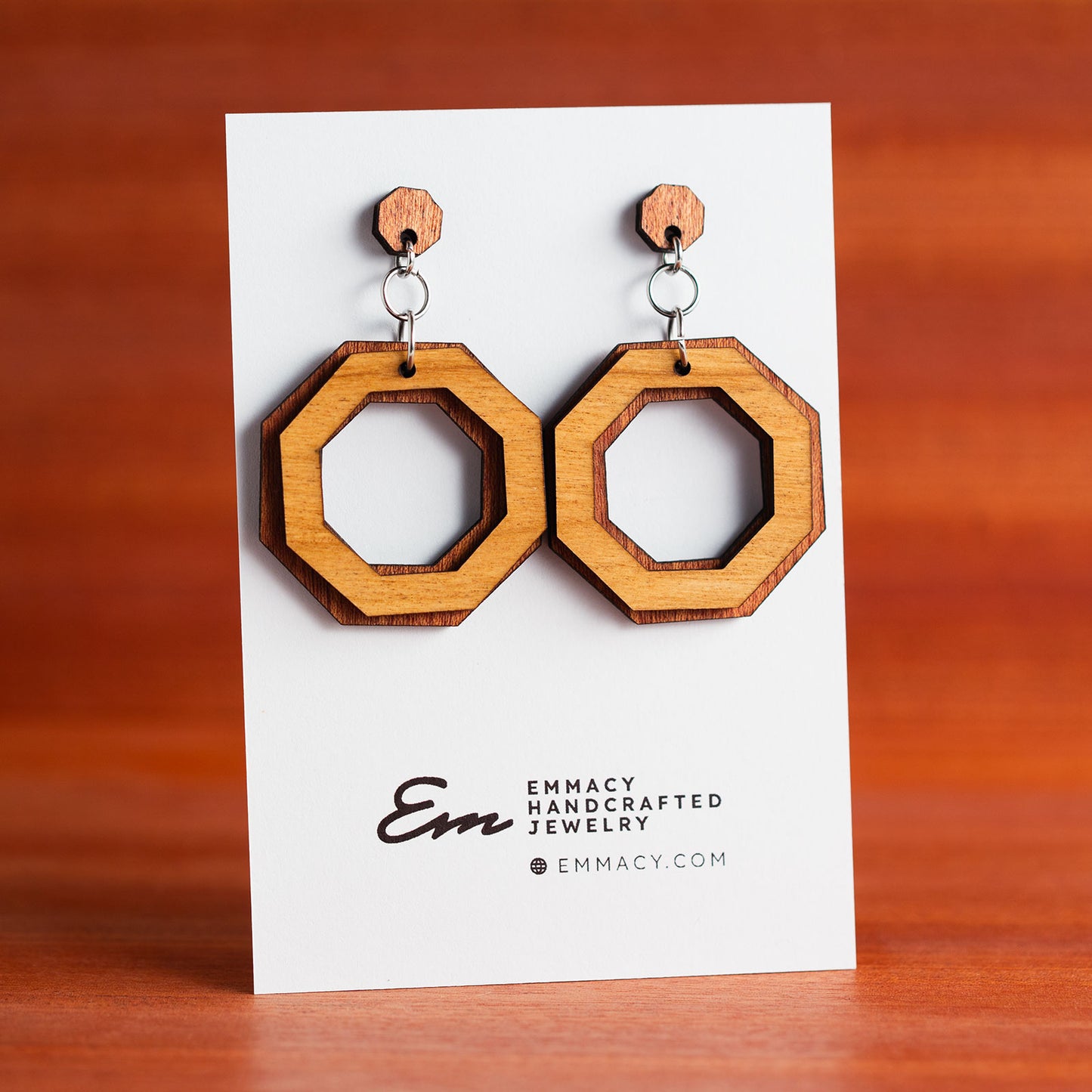 Laser cut wooden dangle earrings in the shape of octagons with the centers removed.