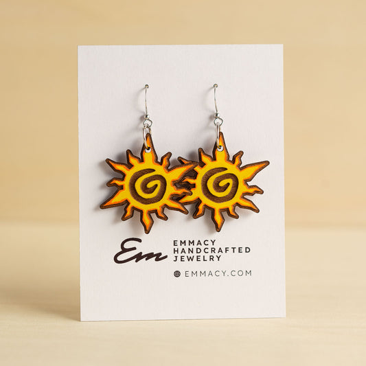 Laser cut wooden dangle earrings cut in the shape of a sun painted orange and yellow.
