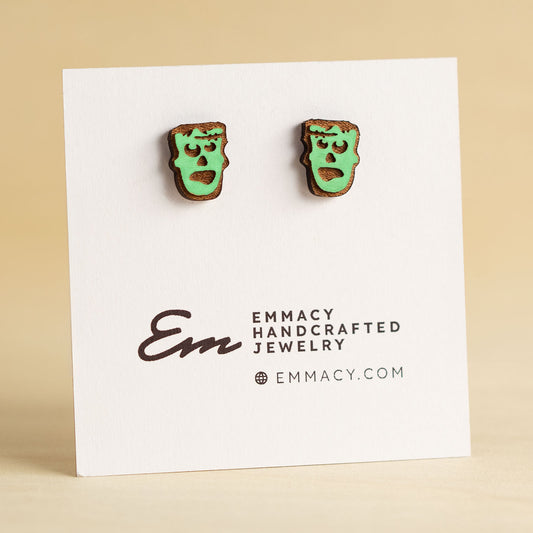 Laser cut wooden stud earrings cut in the shape of Frankenstein's Monster painted green.